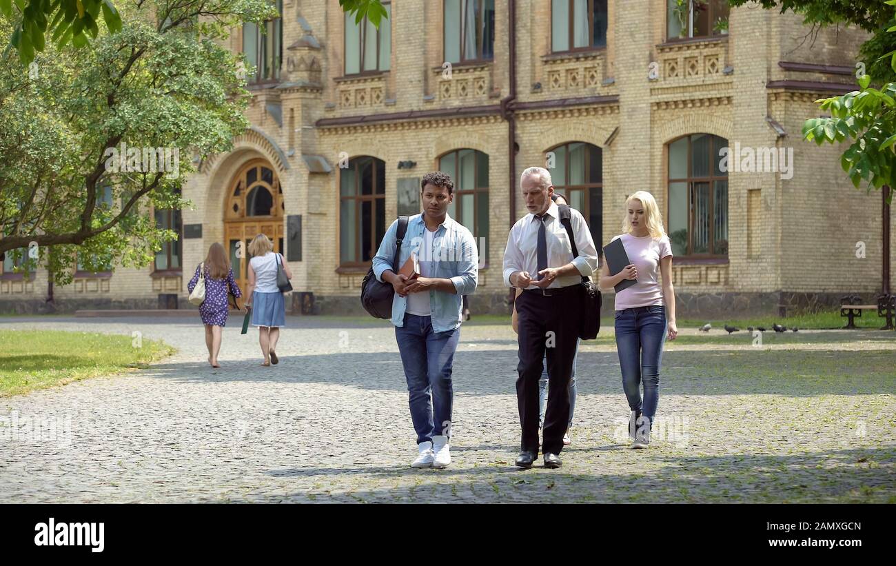Student talking teacher walking hi-res stock photography and images - Alamy