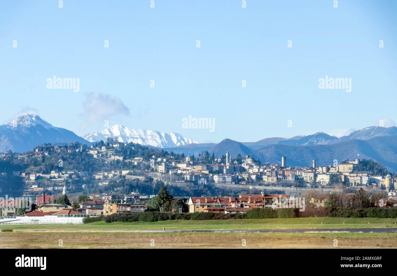 Bergamo, Italy : Panoramic view on Bergamo old town in winter sunny day with blue sky from Il Caravaggio Orio al Serio International airport Stock Photo