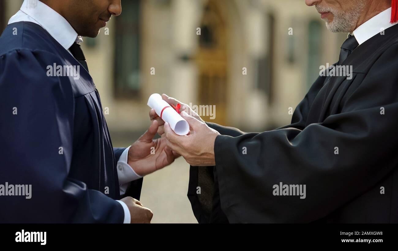 University chancellor giving diploma to graduate student, successful future Stock Photo Alamy