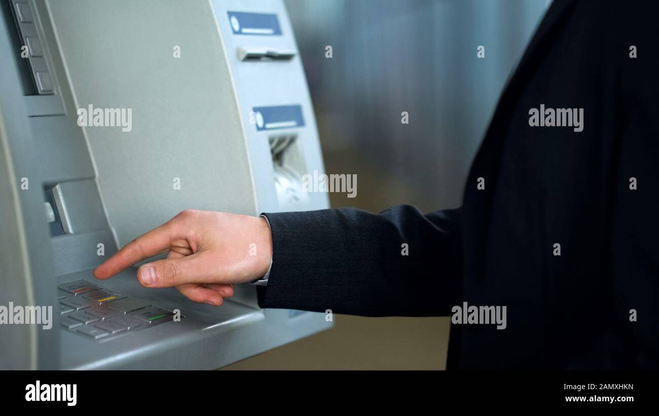 Male hand using ATM, typing pin code and pressing cancel button, system