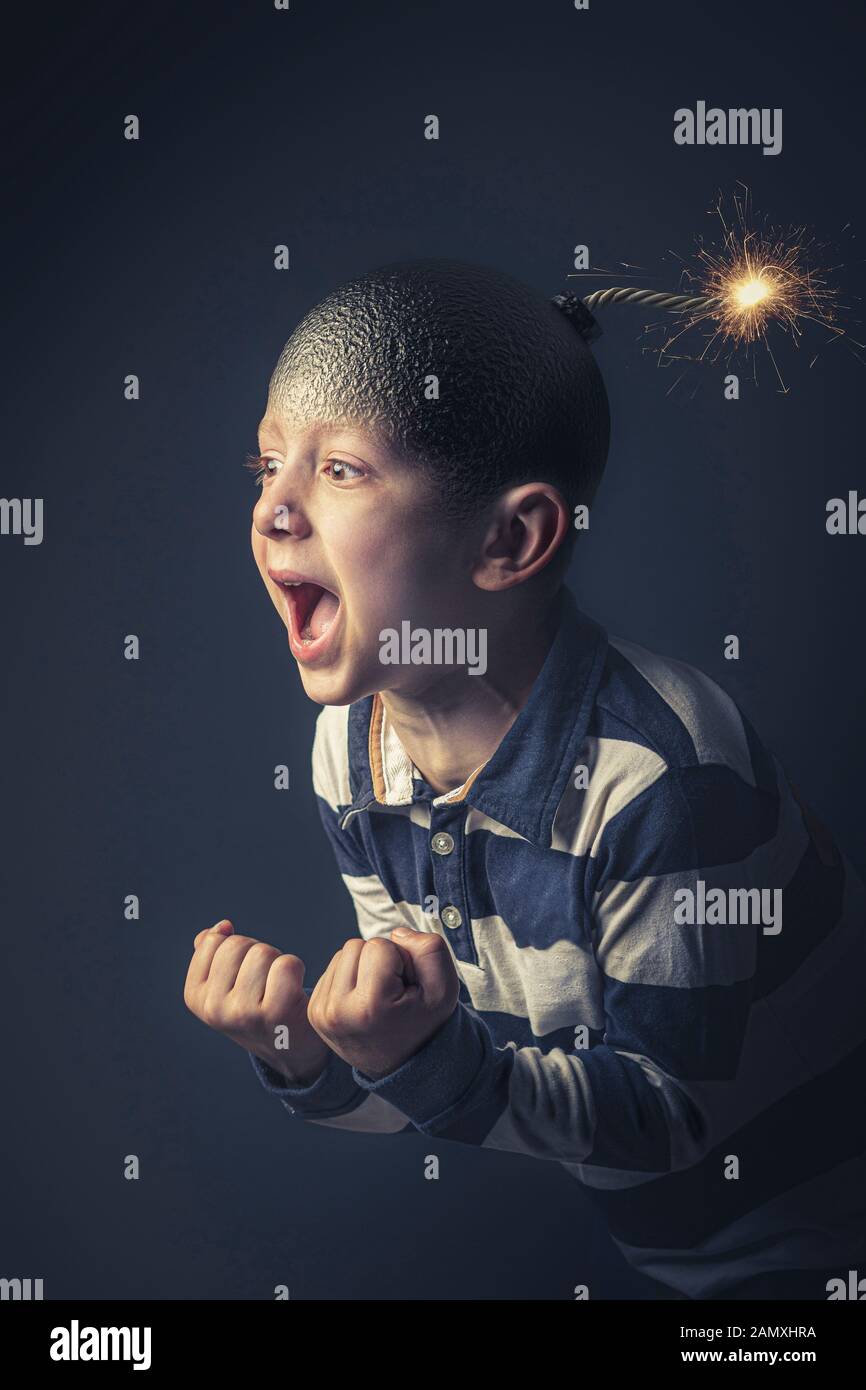 angry caucasian child with bomb shaped head about to explode. Concept of anger and uncontrolled emotions. Vertical format. Stock Photo