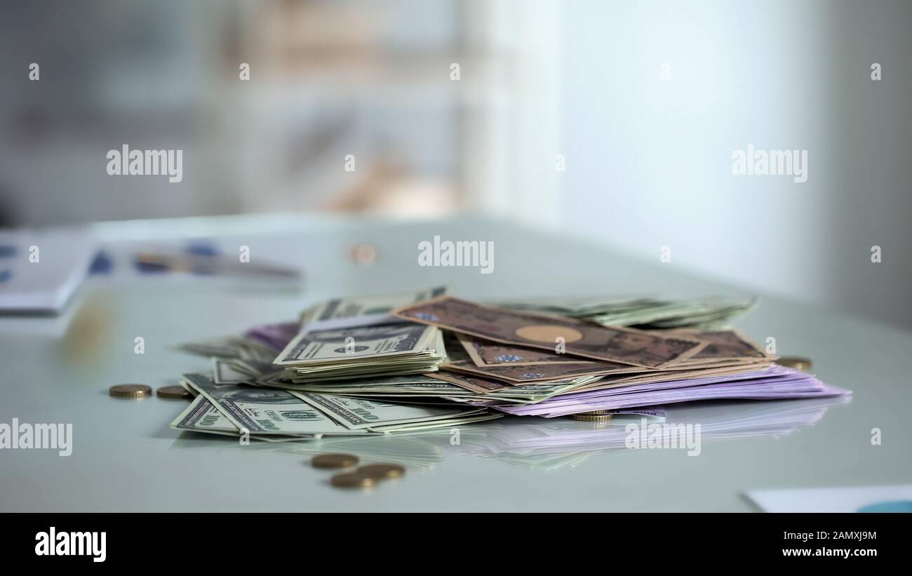 Money on table, foreign currency savings, bank deposit or salary