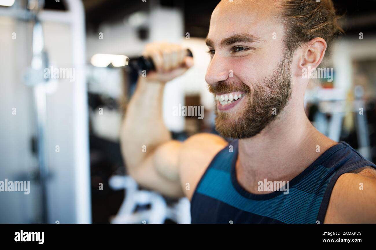Fitness, sport, exercising and lifestyle concep Young man working out in gym Stock Photo