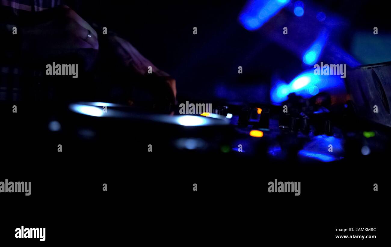 Hands of male dj turning controls on sound equipment, playing music in Stock Photo Alamy