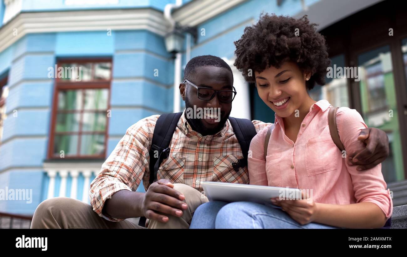 Tourists using travel guide application tablet, educational program for students Stock Photo