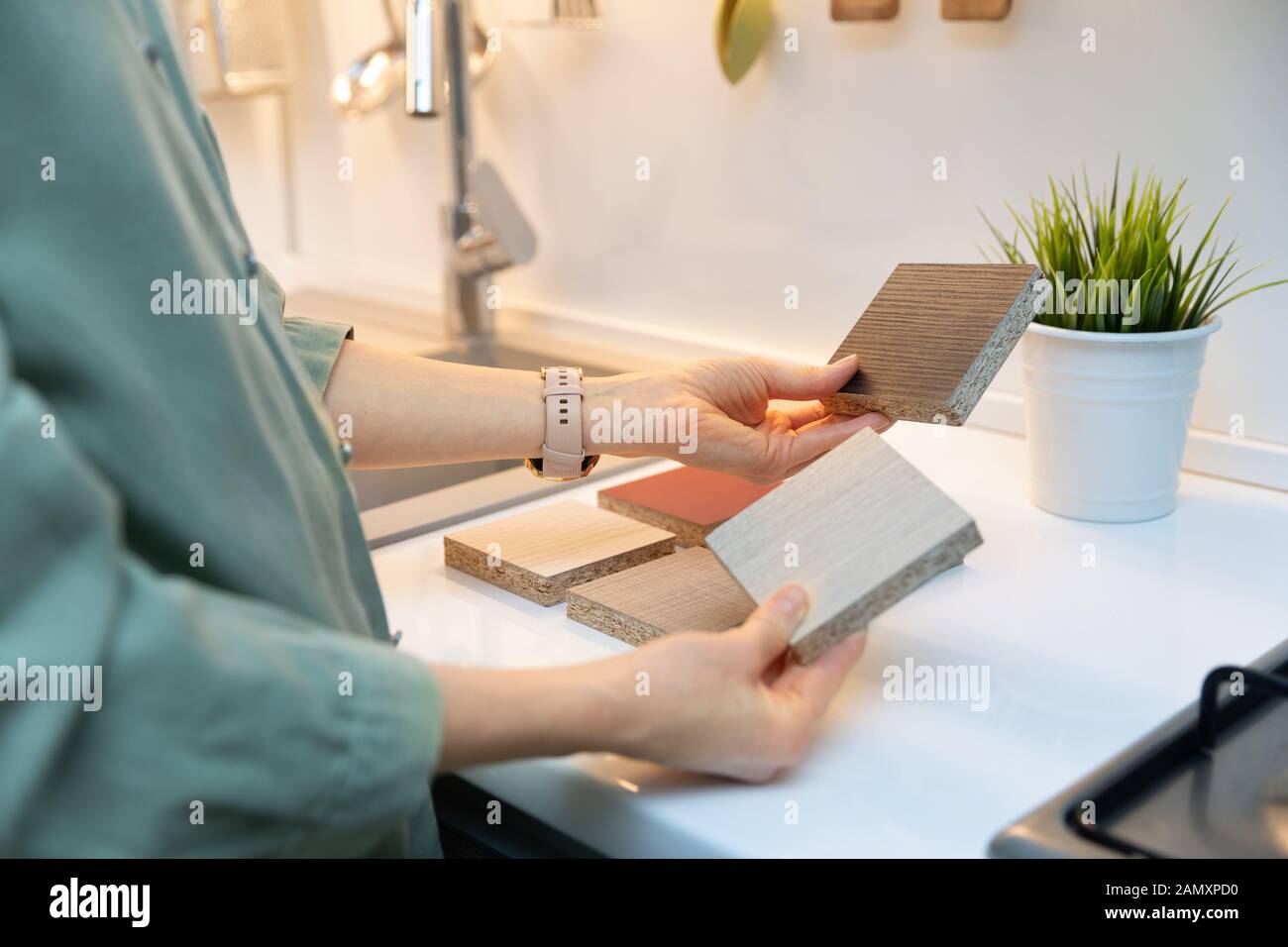 kitchen interior design - woman selecting furniture material texture Stock Photo