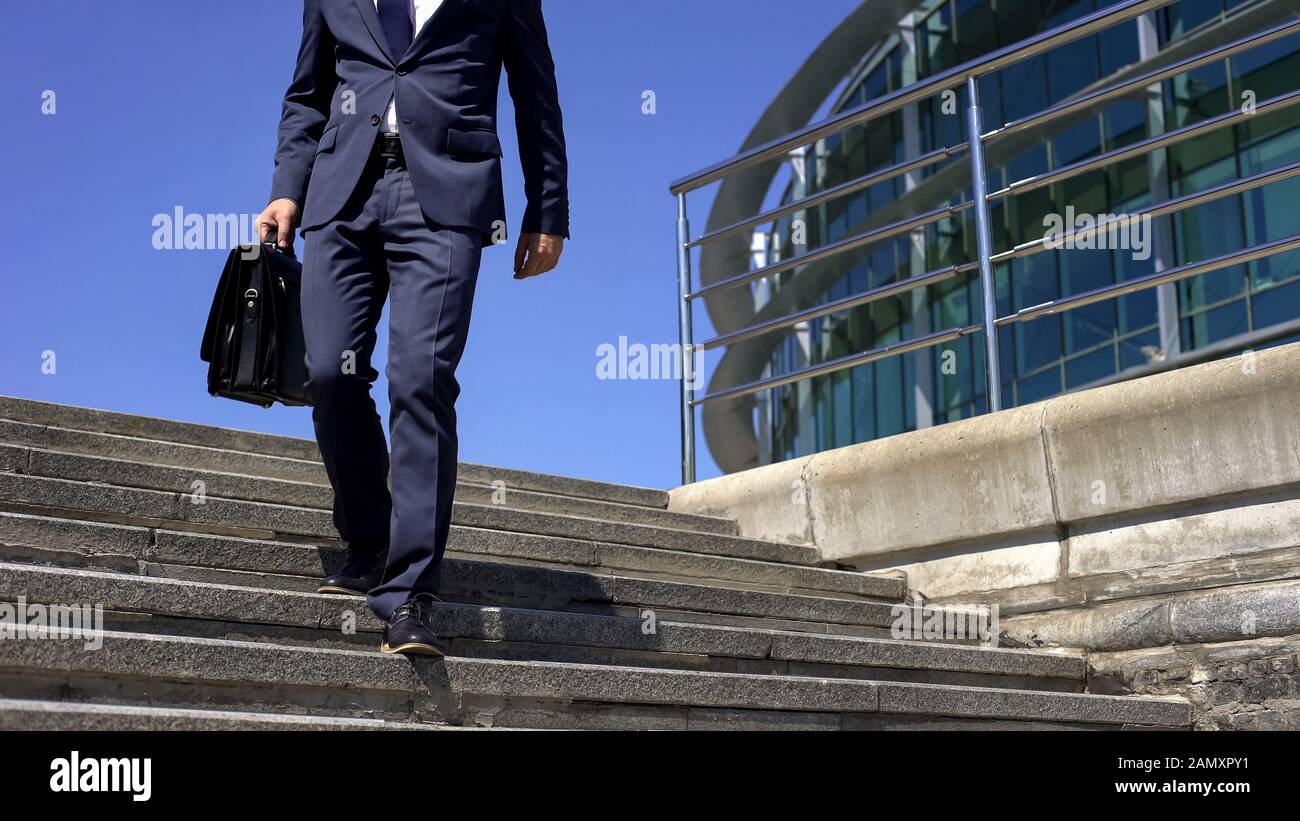 Man in suit feeling back pain, sedentary lifestyle, spinal disc herniation Stock Photo
