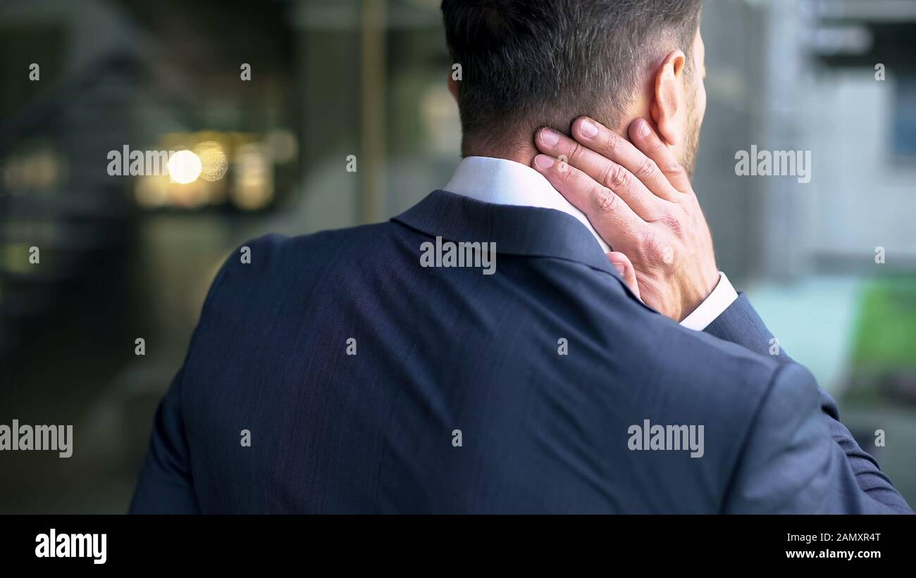 Office male massaging neck muscles, pinched nerve, whiplash injury, inflammation Stock Photo