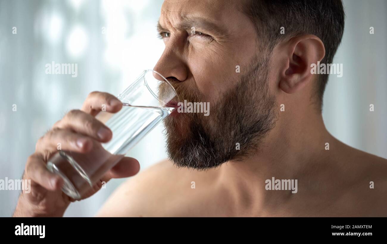 Male rinsing tooth with water, hypersensitivity, sharp dental pain