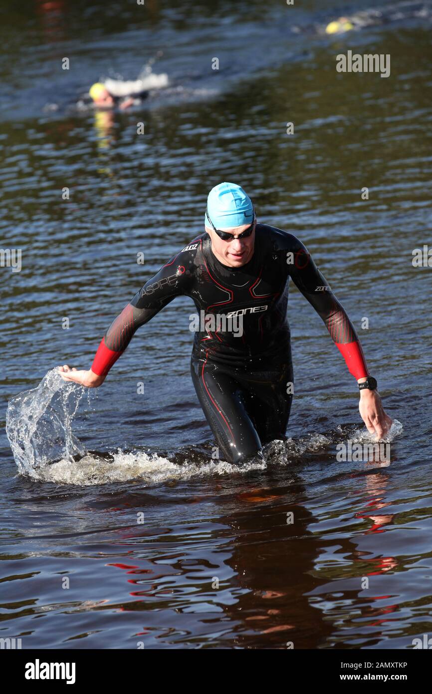 a competitor leaves the water to finish the swim loch lomond open water swimming event Stock Photo