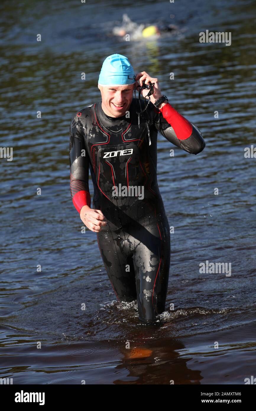 a competitor leaves the water to finish the swim loch lomond open water swimming event Stock Photo