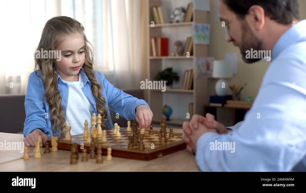 Focused woman thinking about next move and playing chess · Free Stock Photo