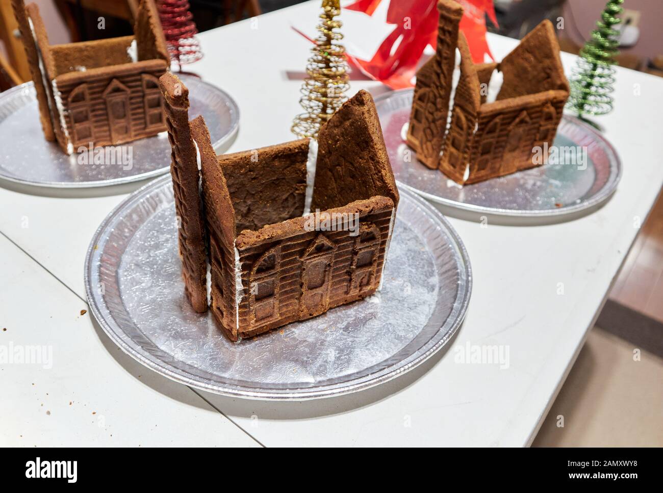 roofless, unadorned, gingerbread houses waiting for the icing to dry before putting the roofs on. Stock Photo