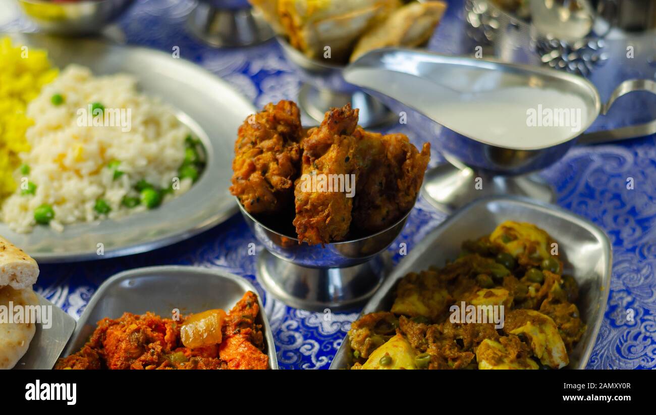 Chicken jalfrezi and chicken curry with various rice and onion Bhajis