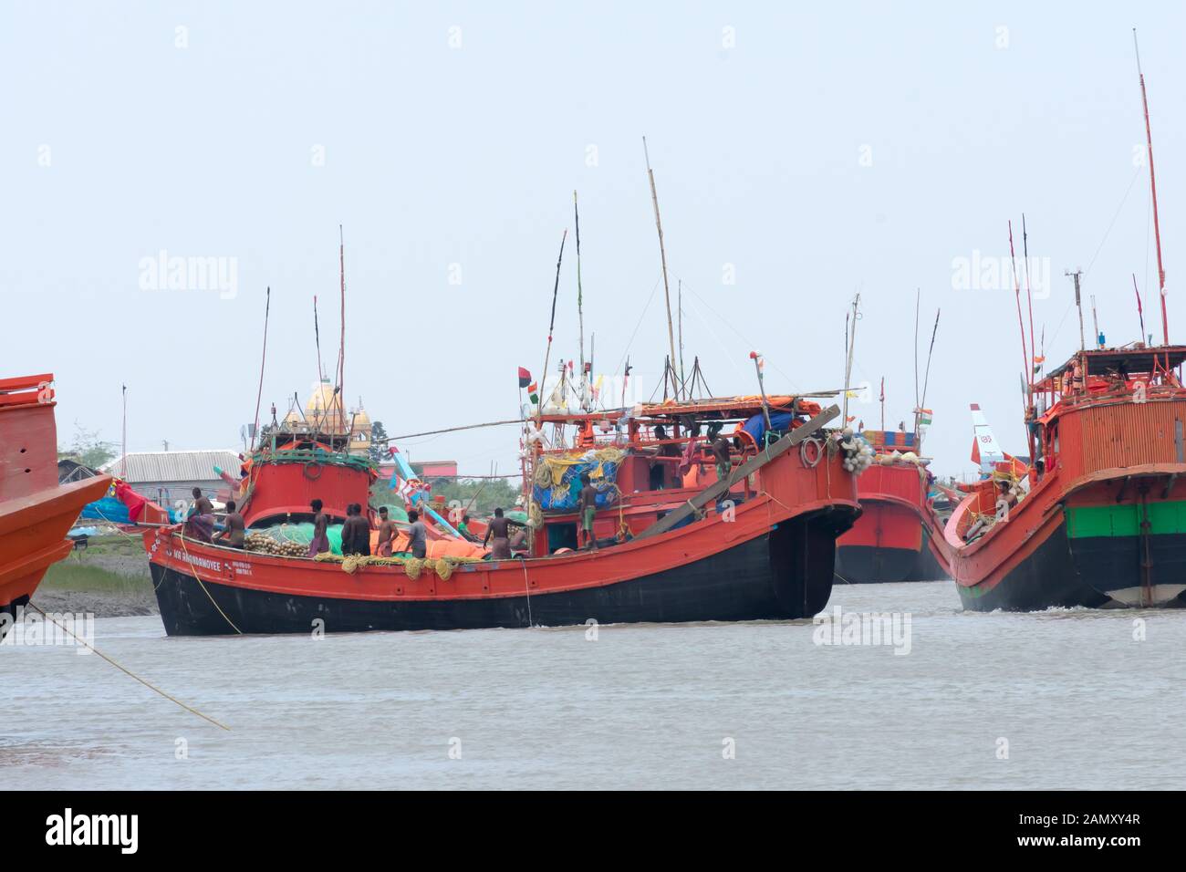 Many Commercial nautical sea vessels like trawler boat ship sailboat, all Red and Black Color code to strength coastal security anchored in protected Stock Photo