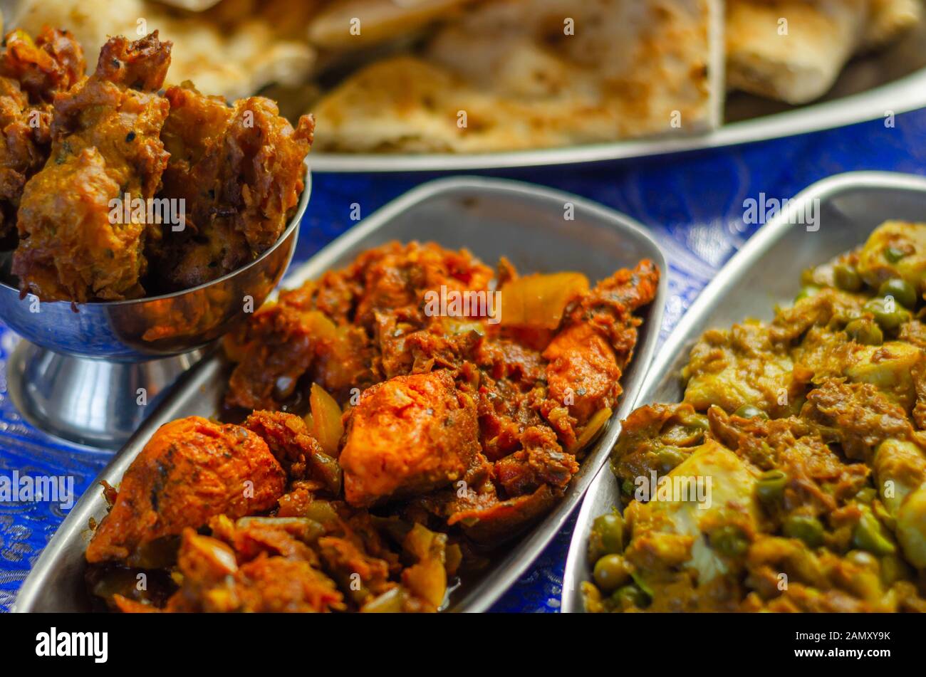 Chicken jalfrezi and chicken curry with various rice and onion Bhajis