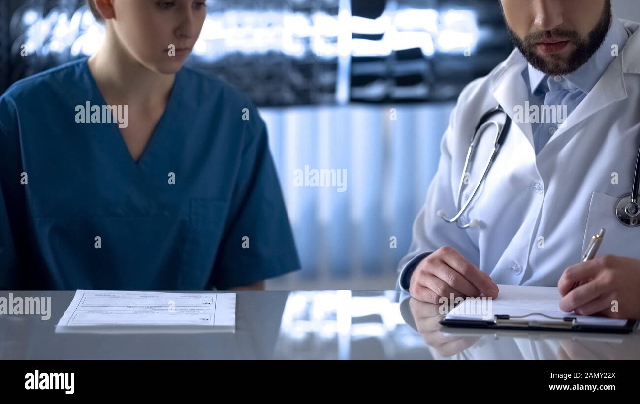 Laboratory worker taking bribe from doctor, fake analyses, corruption medicine Stock Photo