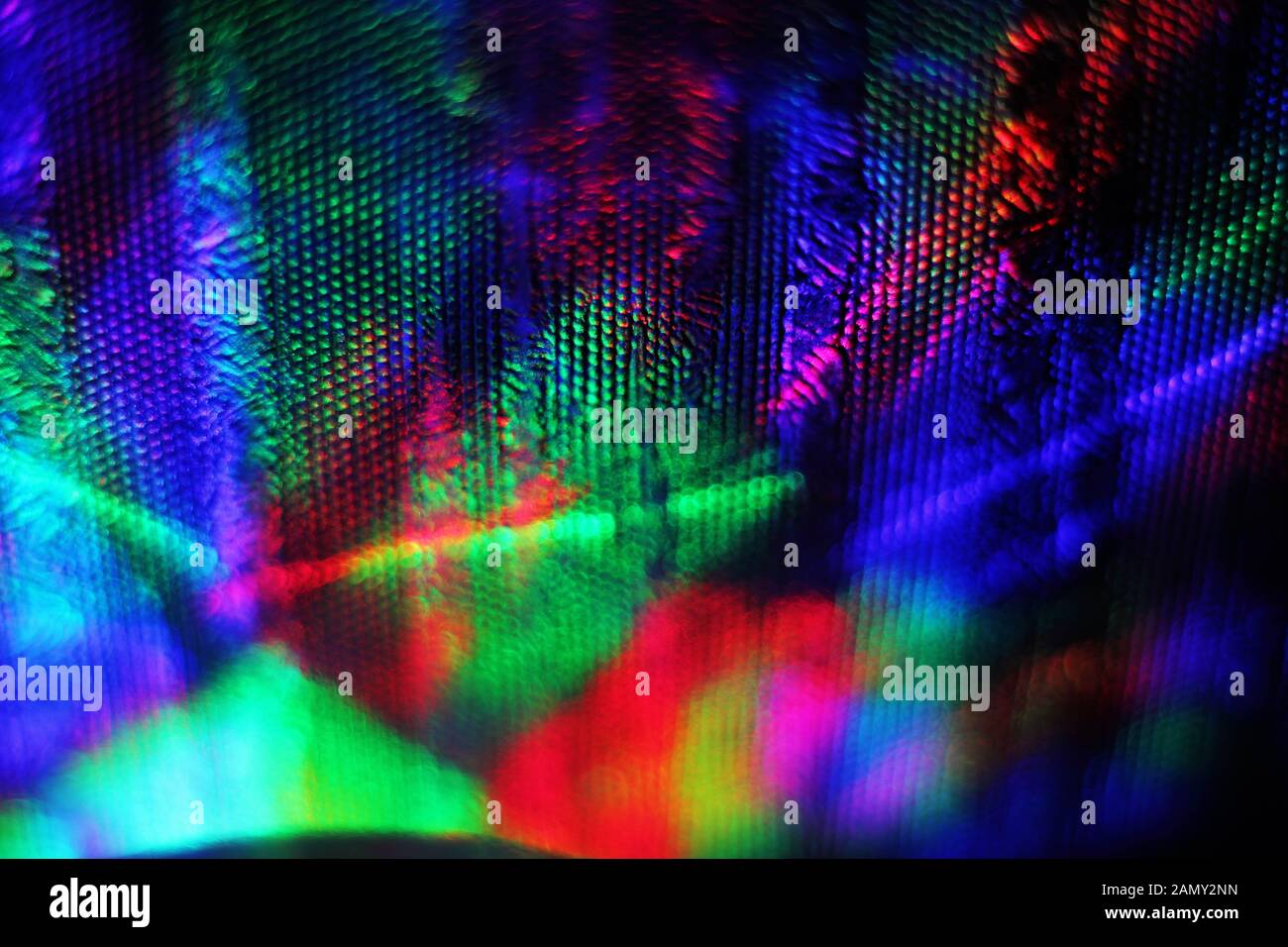 The wall is illuminated by multi-colored light sources. Beautiful abstract multicolored background. Stock Photo