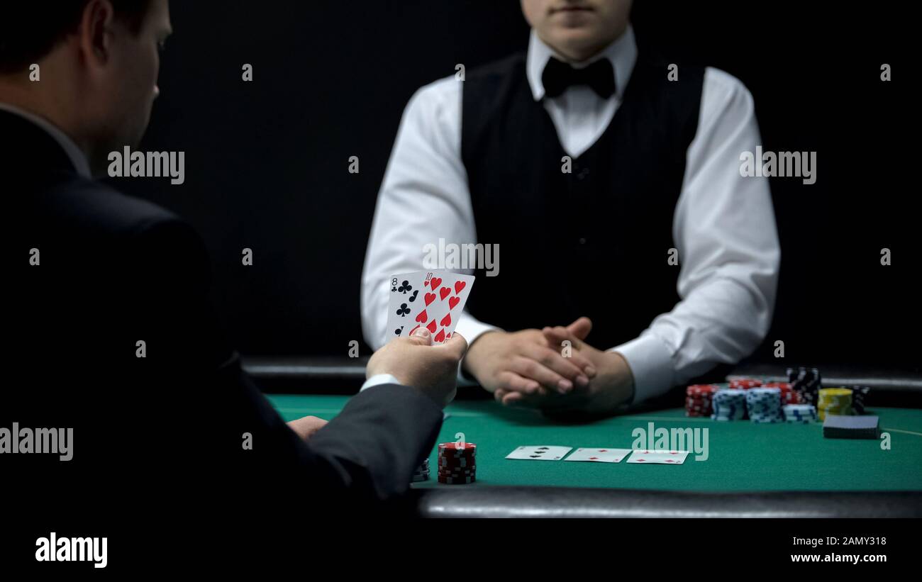 Upset businessman having bad cards combination in poker, weak hand casino wins Stock Photo