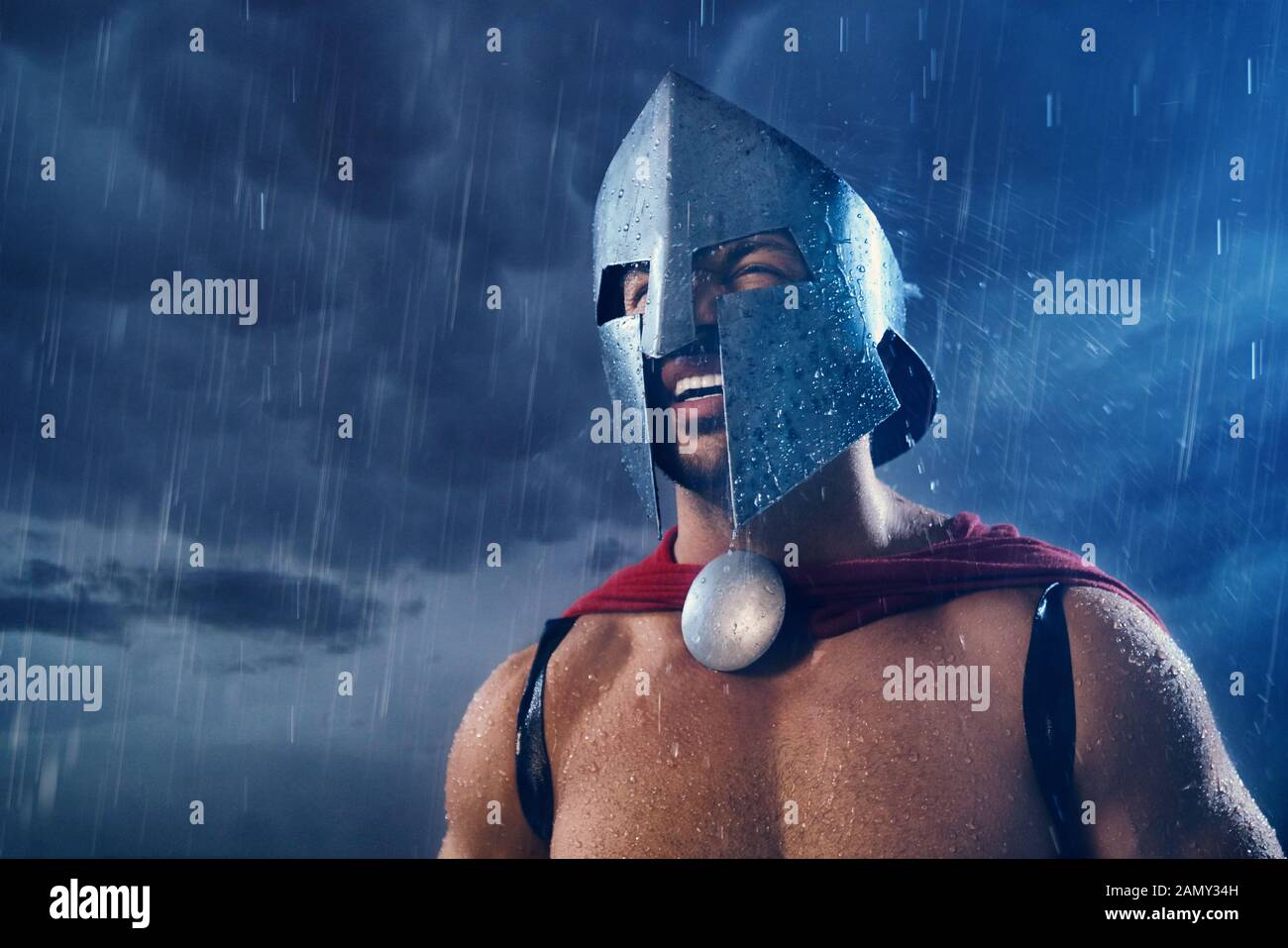 Portrait of spartan warrior standing and getting wet in rain. Close up
