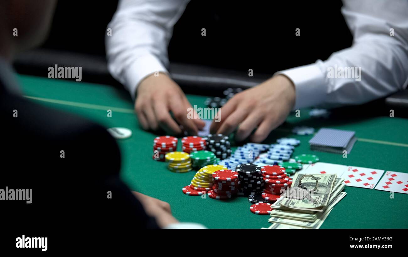 Poker game, player has winning cards combination, bets all cash and house keys Stock Photo