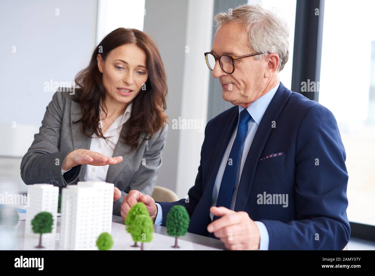 Business couple over architectural model Stock Photo