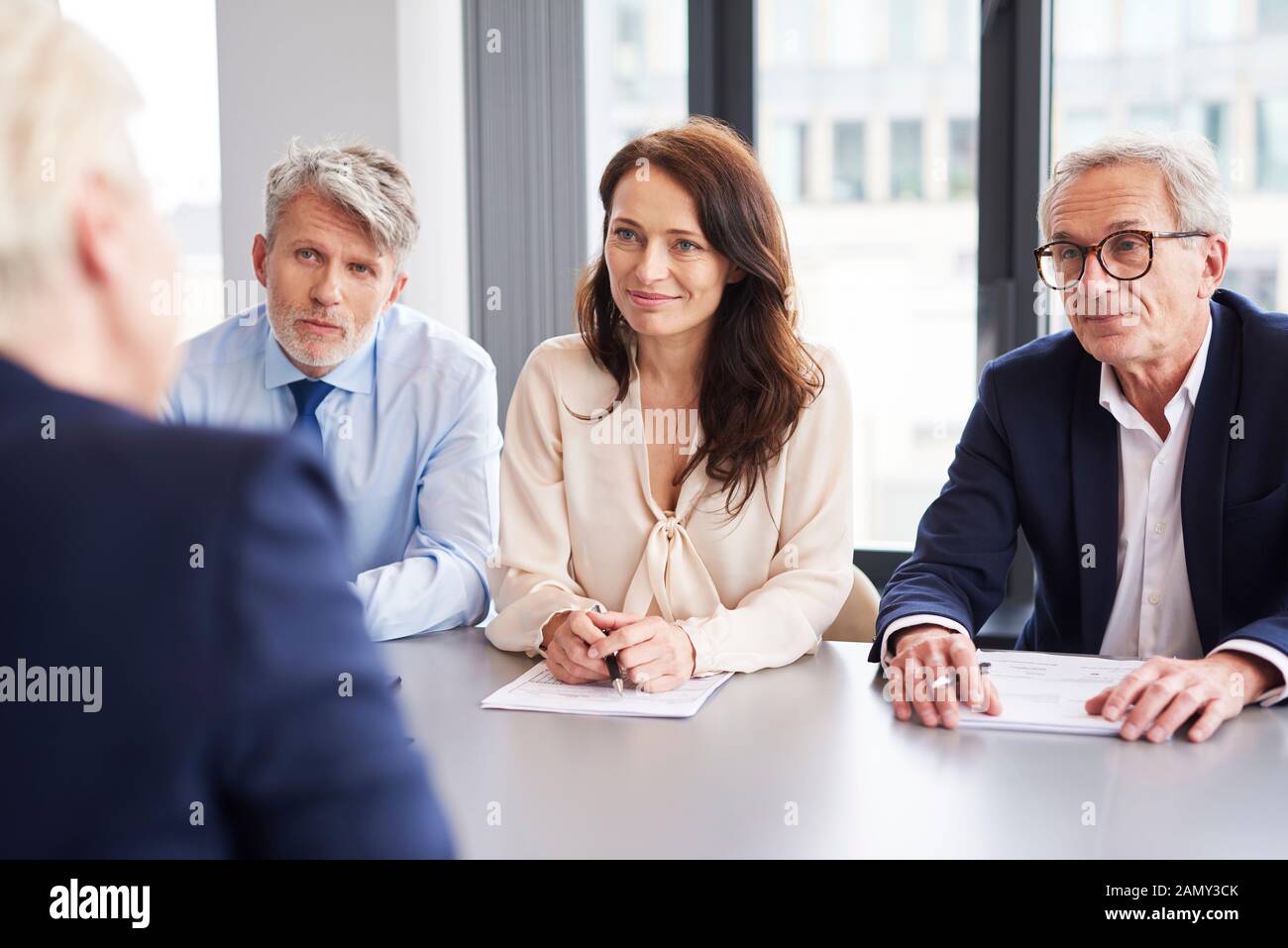 Serious, business talks at conference table Stock Photo