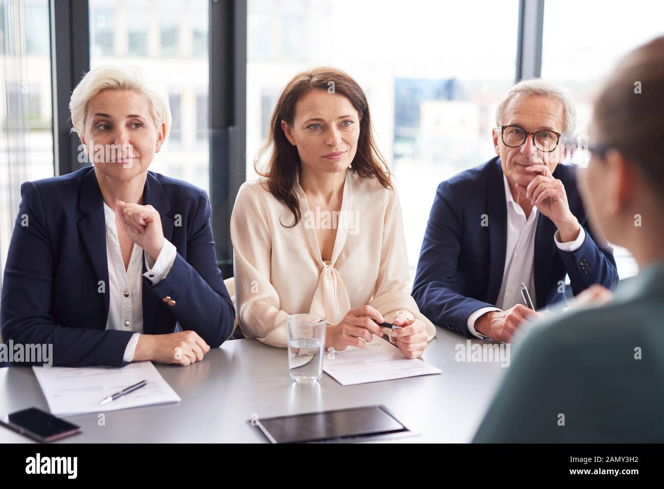 Business people having a conversation at conference table Stock Photo