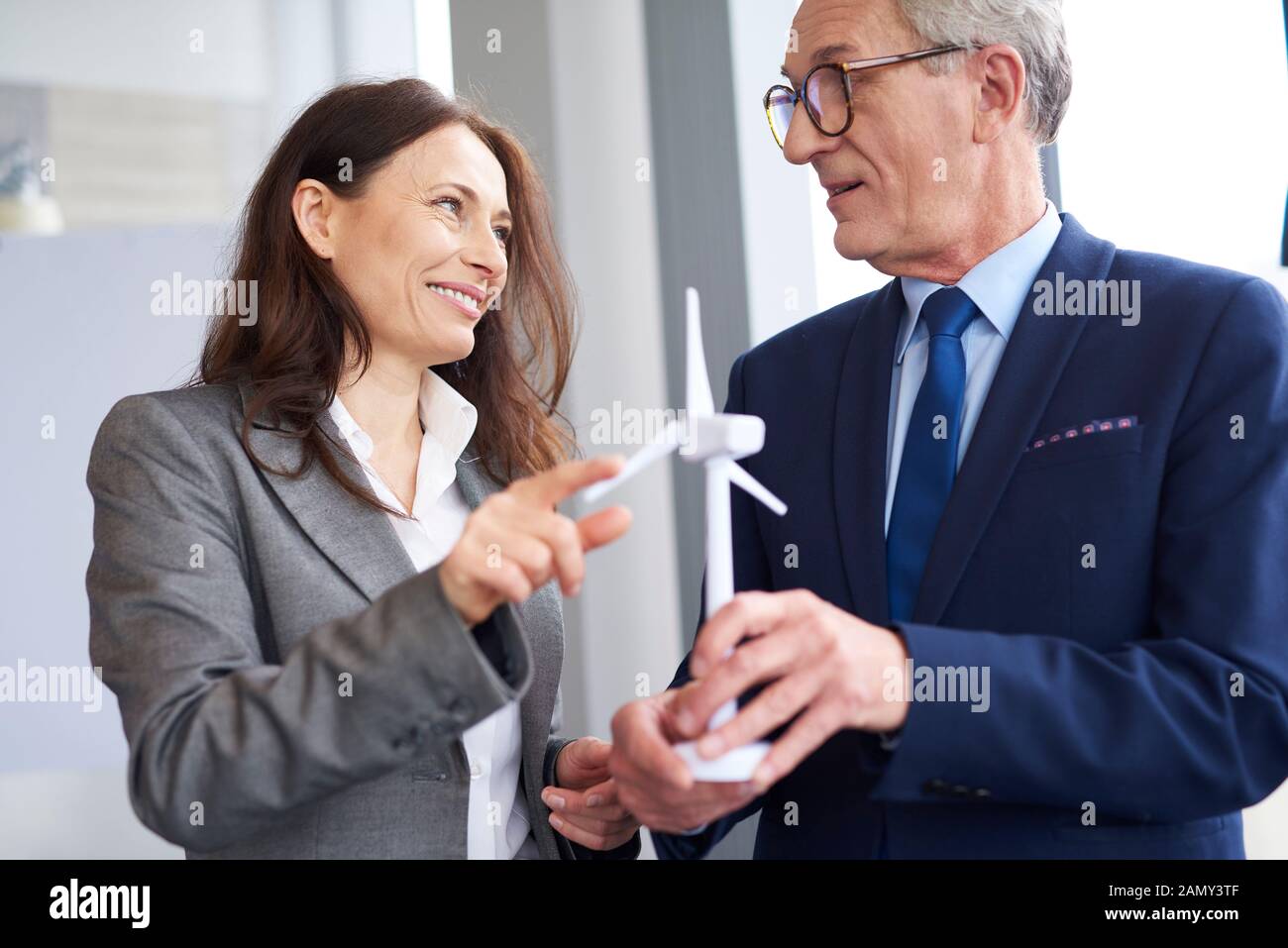 Business workers having a conversation about wind energy Stock Photo