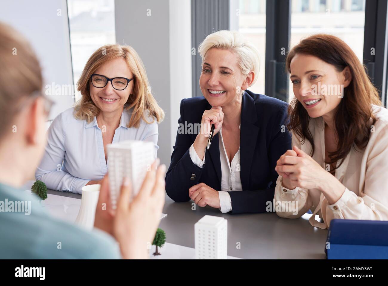Three mature businesswomen having a conversation at conference table Stock Photo