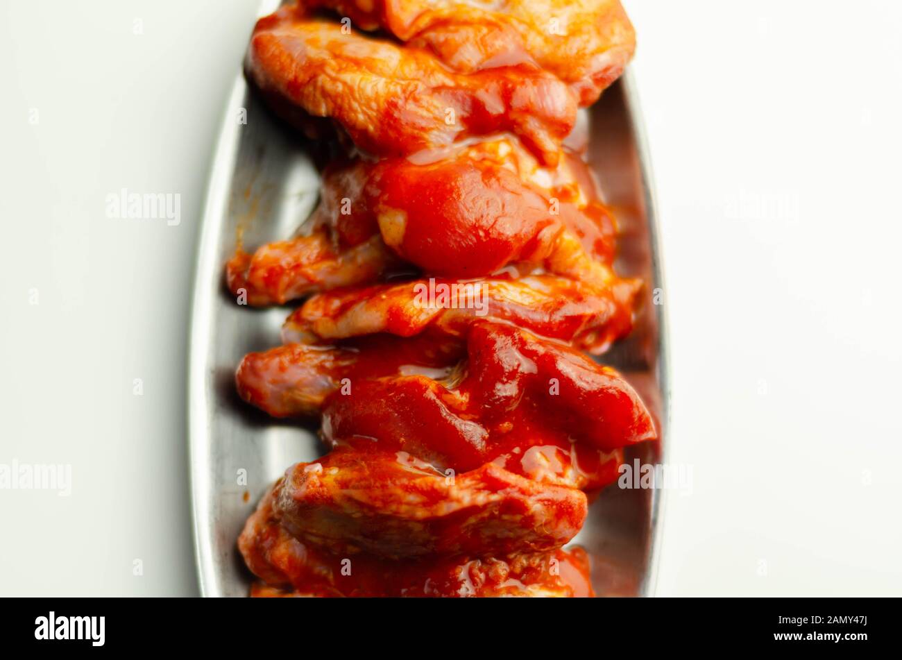 Raw and fresh chicken wings in a Chinese marinade, ready for grilling Stock Photo Alamy