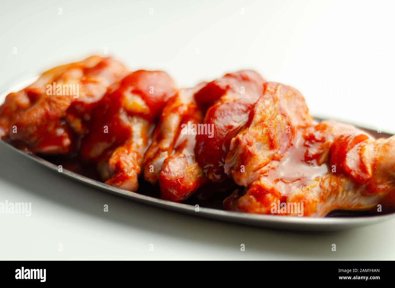 Raw and fresh chicken wings in a Chinese marinade, ready for grilling Stock Photo Alamy