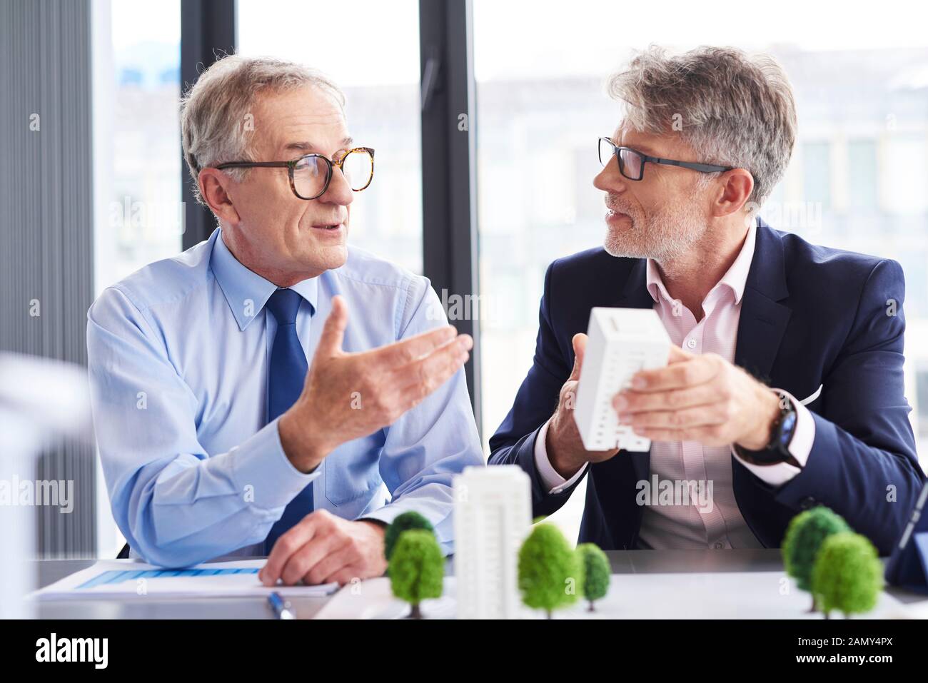 Two mature architects discussing business strategy Stock Photo