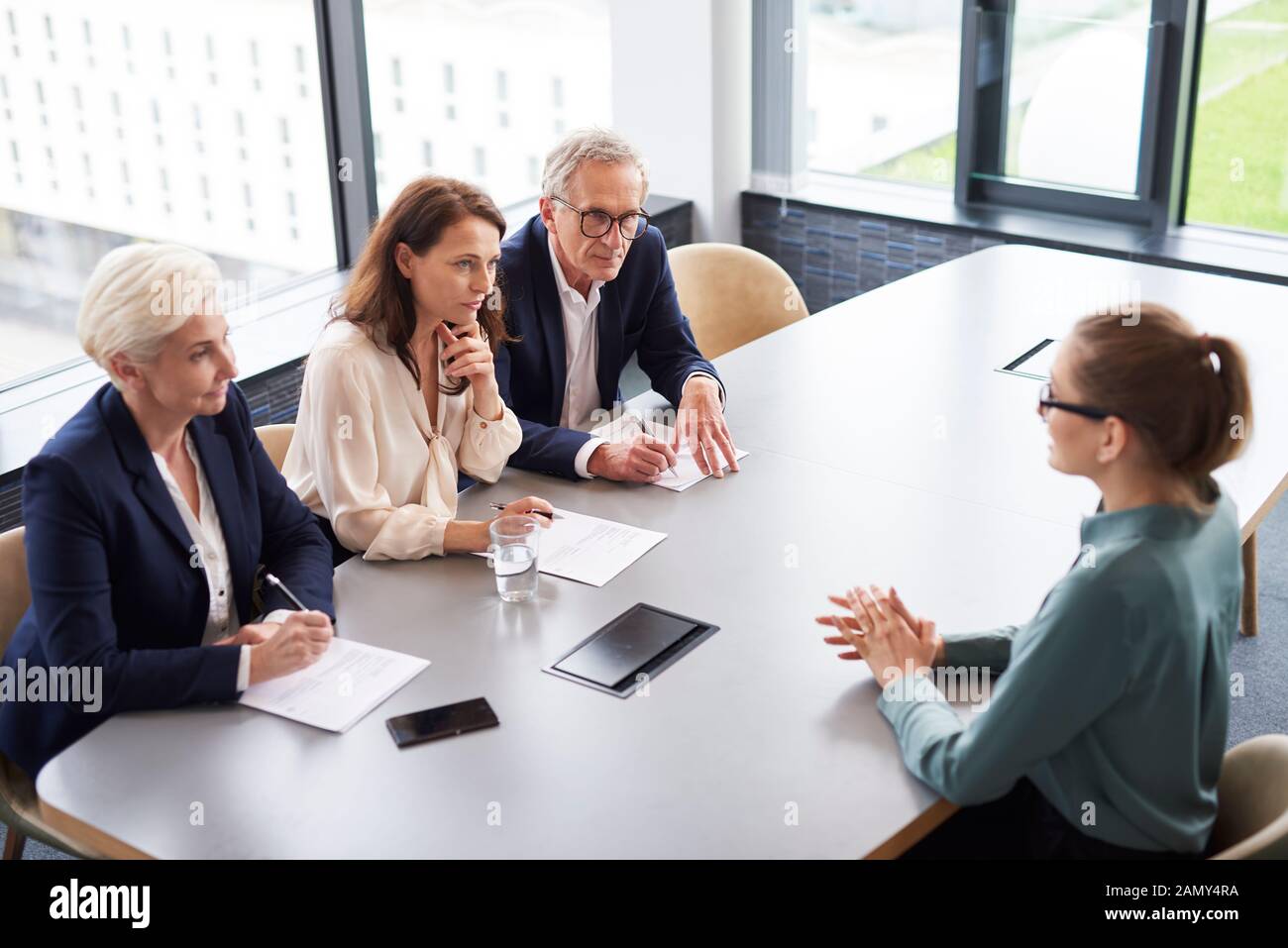 Woman during job interview and three elegant members of management Stock Photo