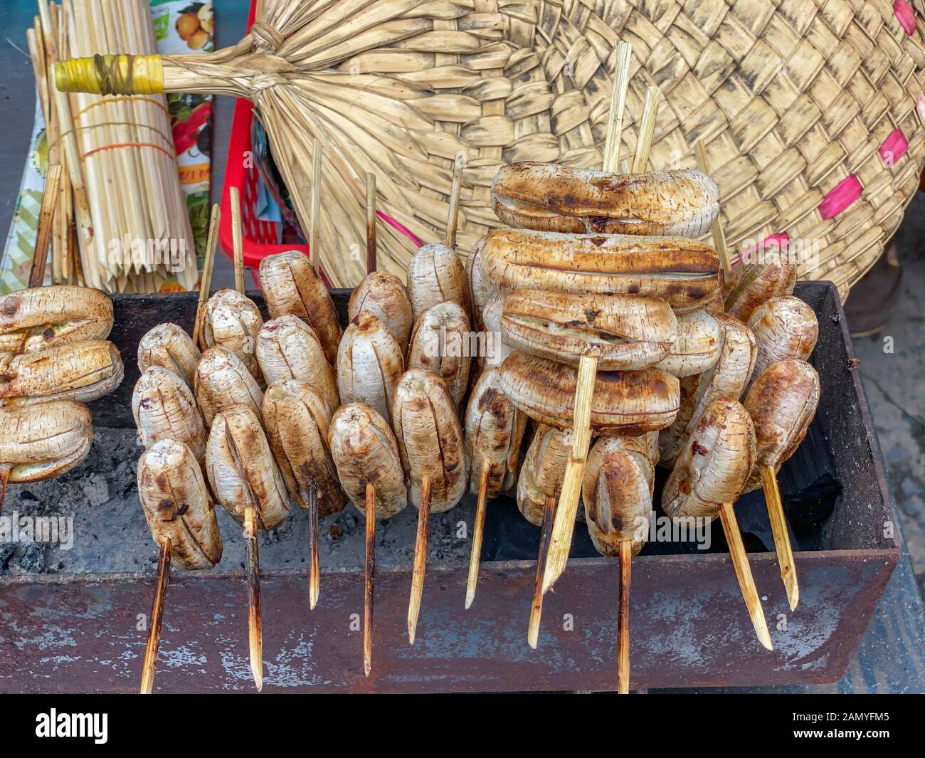 Rustic and tasty Cambodian grilled sweet banana at street market Stock