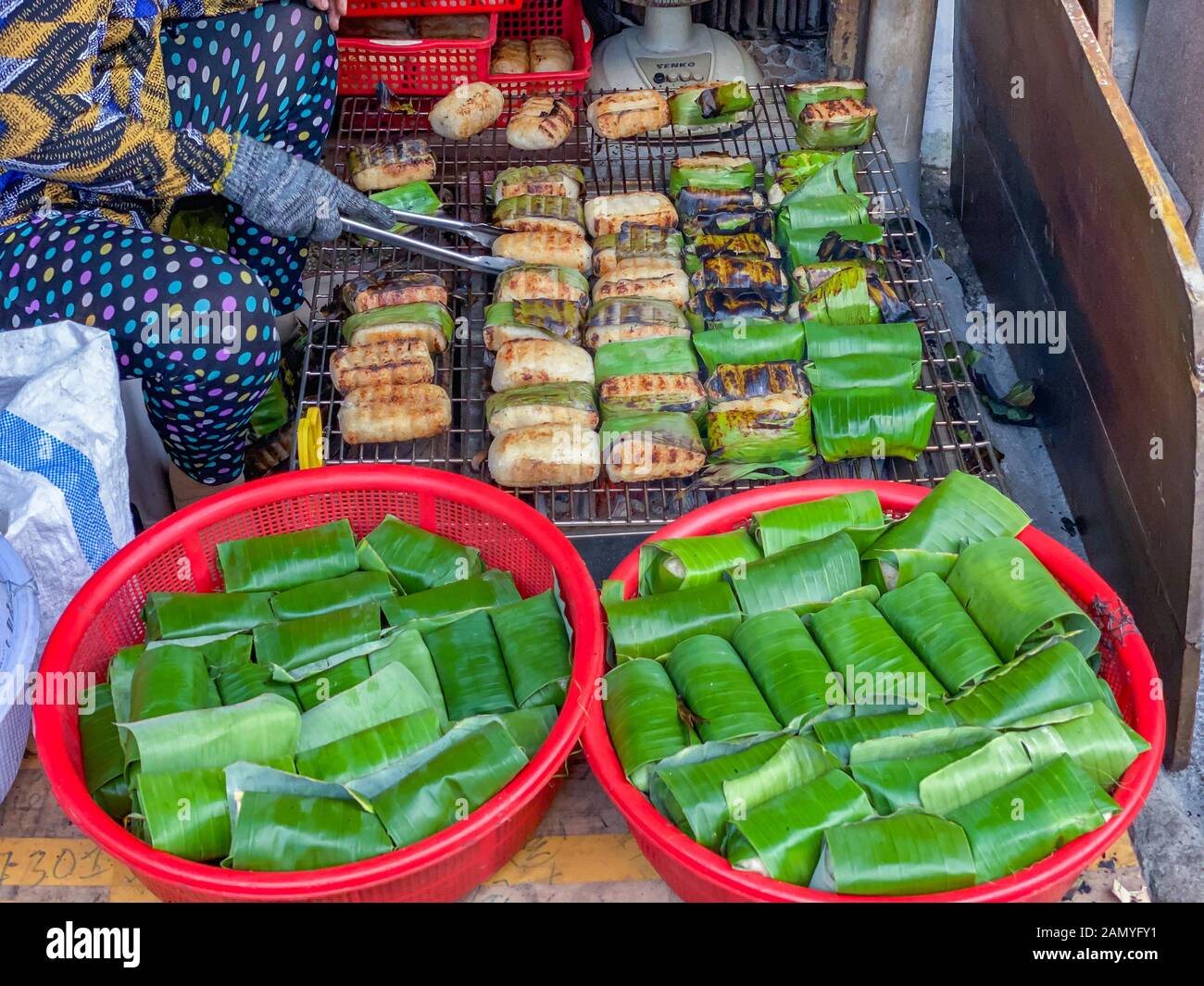 Grilled banana sticky rice in Cambodia street food market Stock Photo