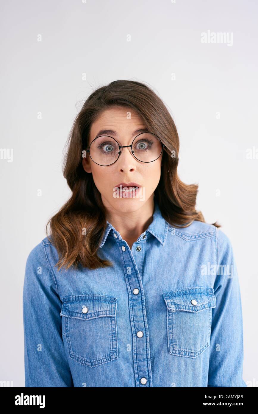 Portrait of shocked woman at studio shot Stock Photo