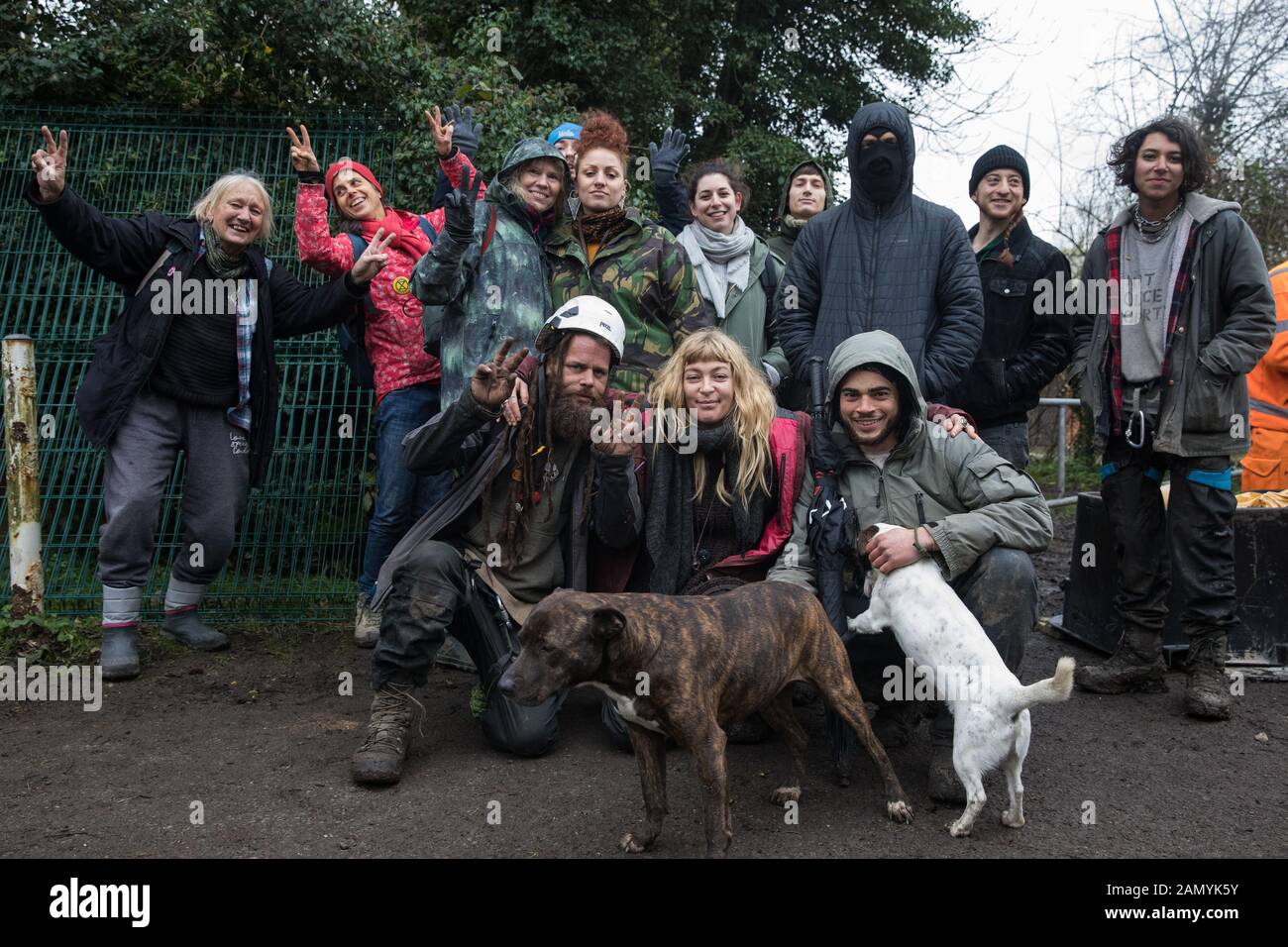 Harefield, UK. 13 January, 2020. Stop HS2 activists pose alongside a gate being erected by a team of engineers and enforcement agents across a public Stock Photo