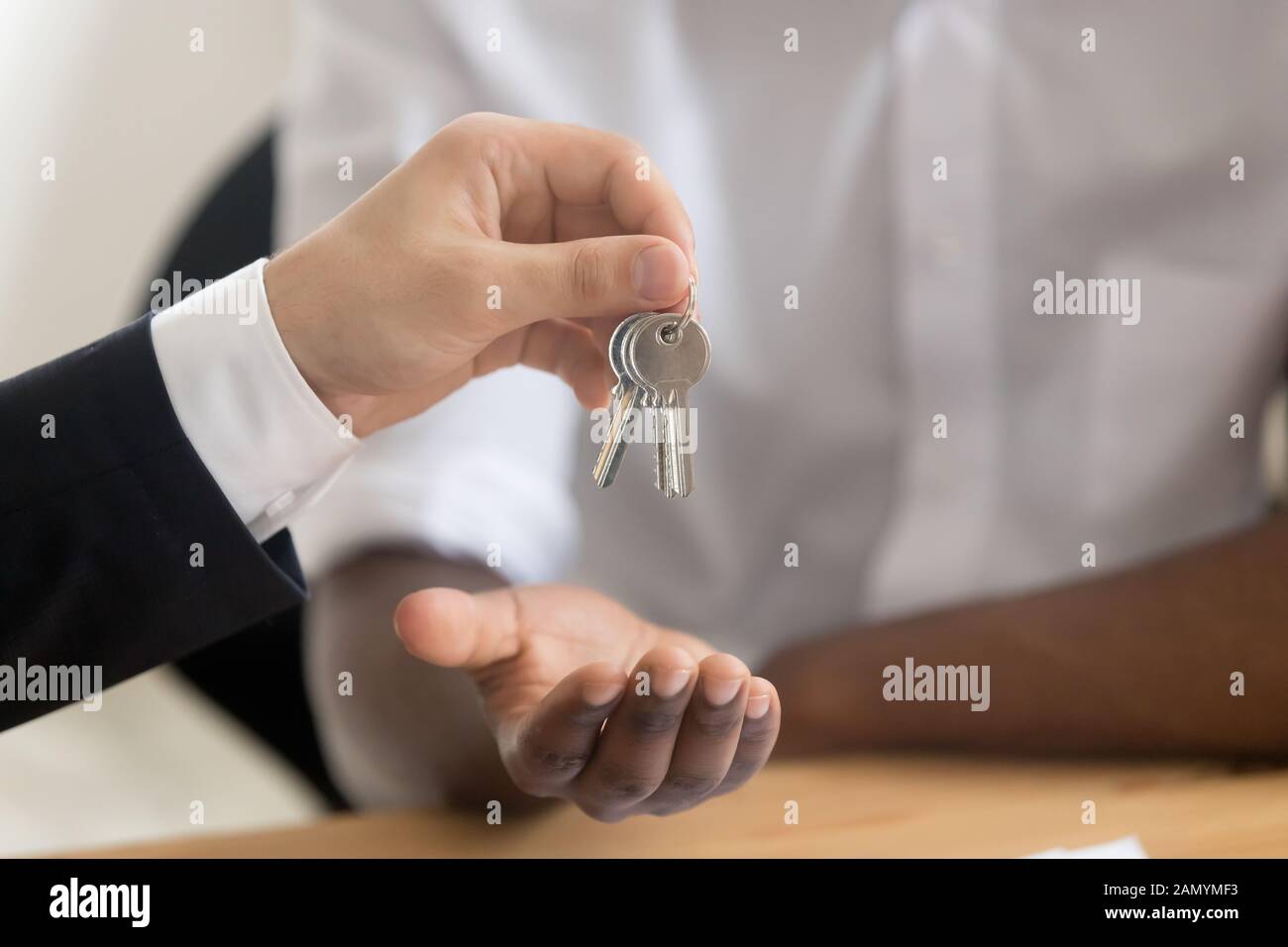 Close up of realtor give keys to property buyer Stock Photo