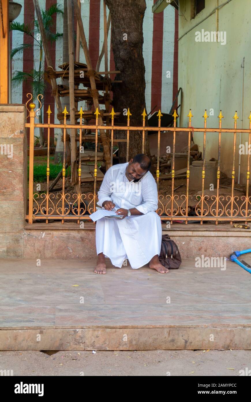 An indian man talking on mobile in the street with traditional clothing,  Madurai, South India Stock Photo