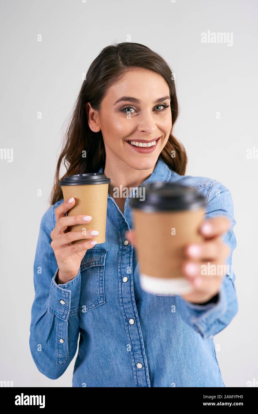 Portrait of smiling woman holding disposable cup of coffee Stock Photo ...