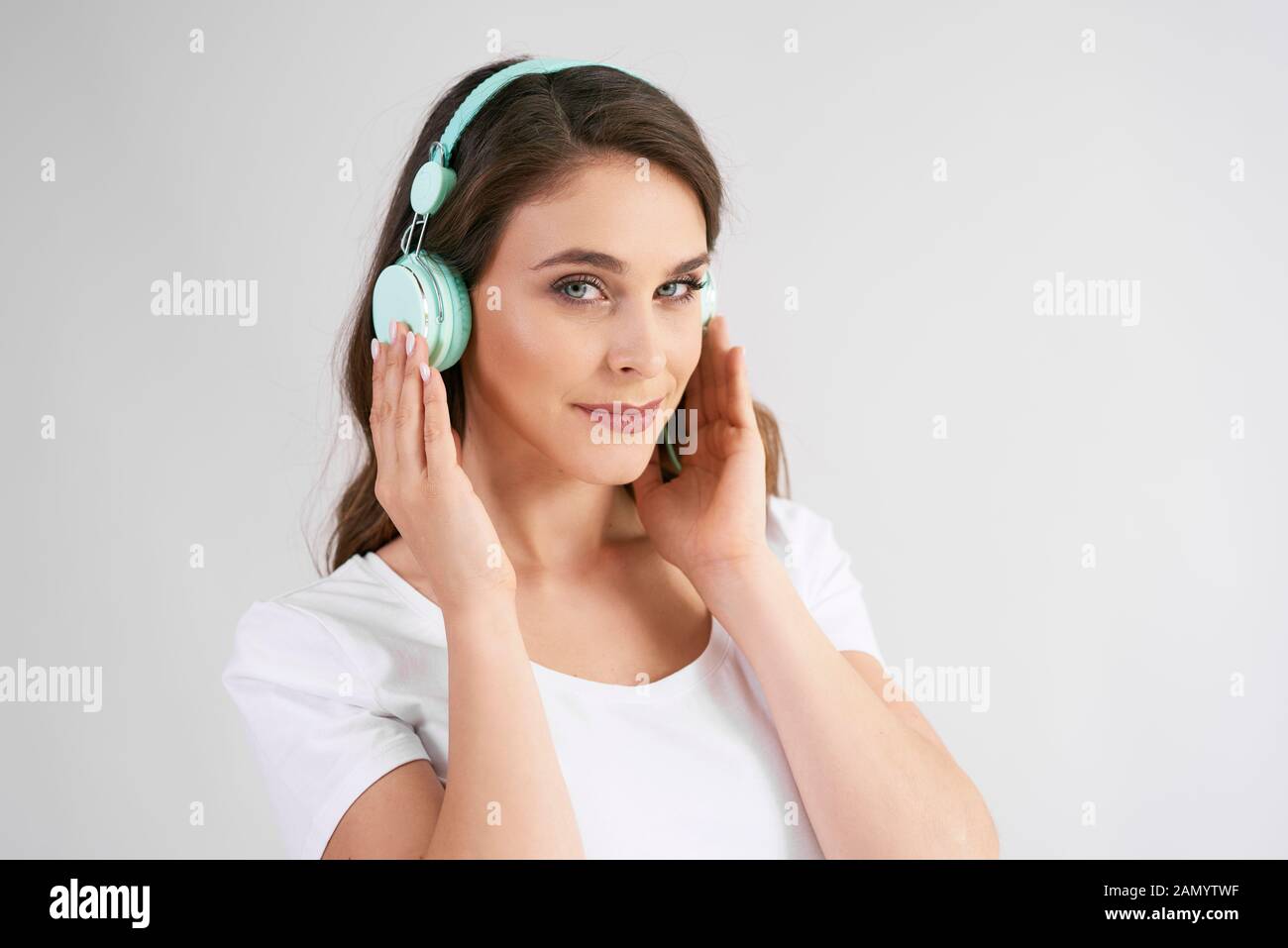 Portrait of young woman with headphones listening to music Stock Photo
