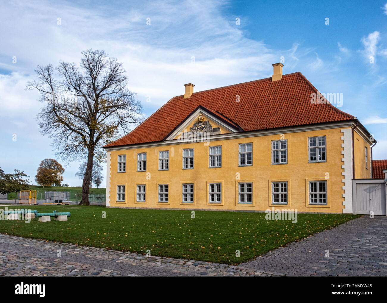 The Commander's House. Baroque-style two-storey yellow & white building with red tile roof by architect Elias Häuser  - Kastellet, Copenhagen, Denmark Stock Photo