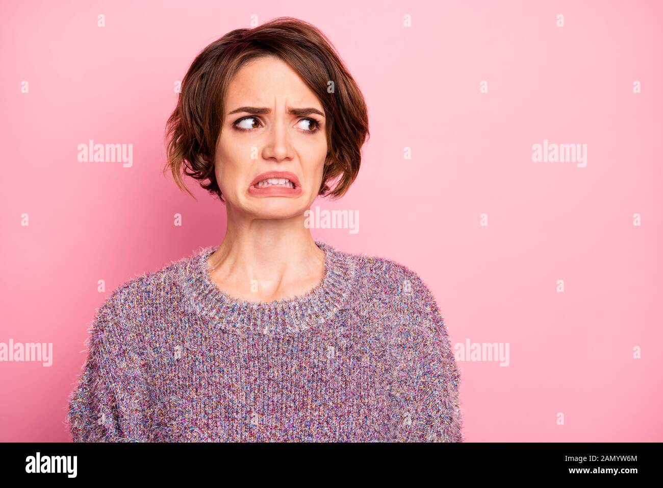 Close-up portrait of her she nice attractive lovely pretty brown-haired girl unpleasant look reaction grimacing isolated over pink pastel color Stock Photo