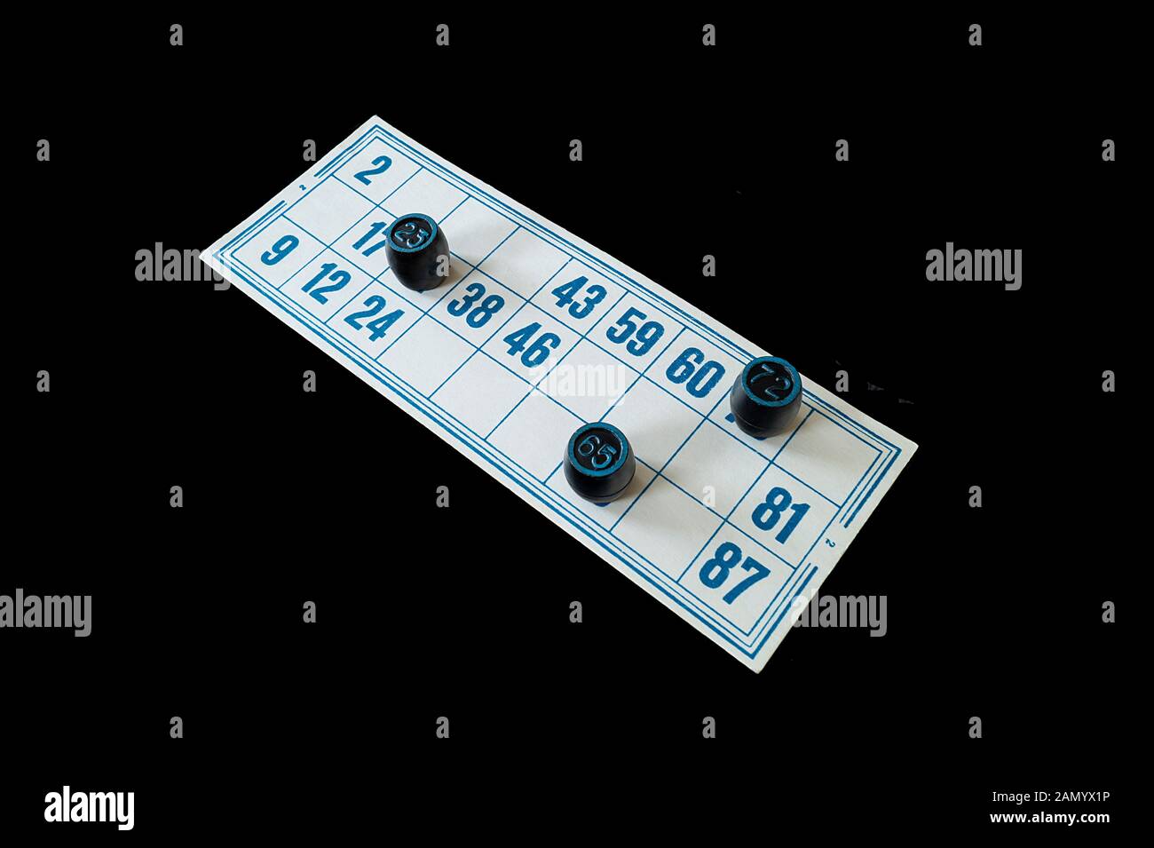 Blanching card lotto with blue number on black background. The Black cask with number in turn blue the circle. Photography type overhand Stock Photo