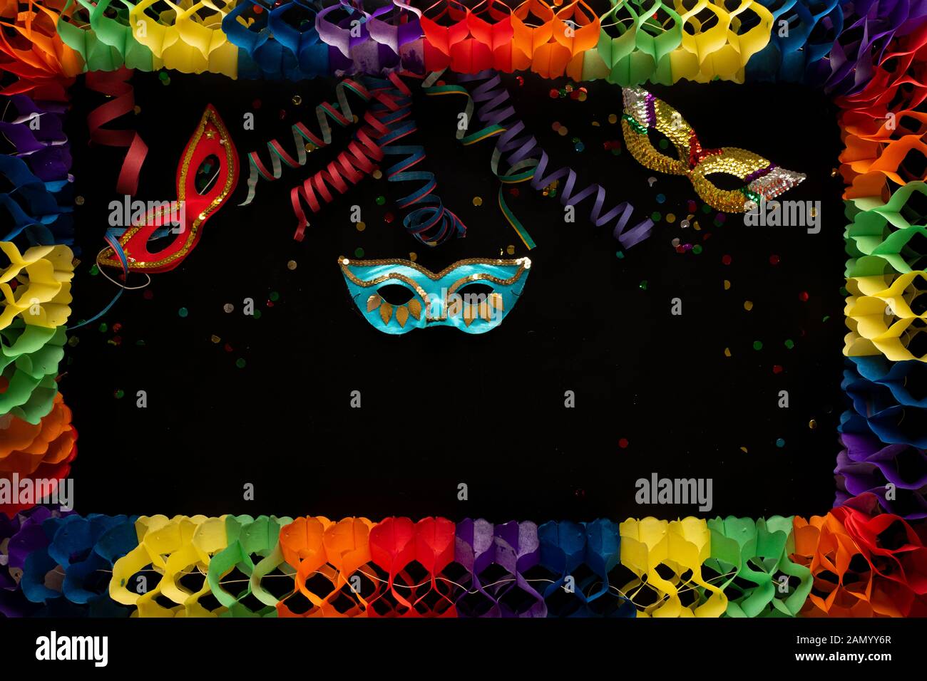 Carnival objects on a black background. Coiled streamers, confetti, horn, tambourine, balloons and many other carnival objects Stock Photo