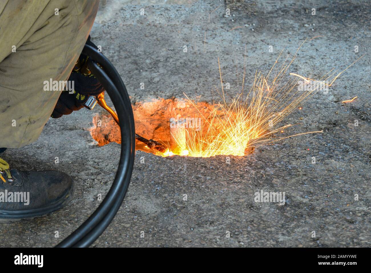 A gas cutter in production, a welder removes unnecessary metal residues