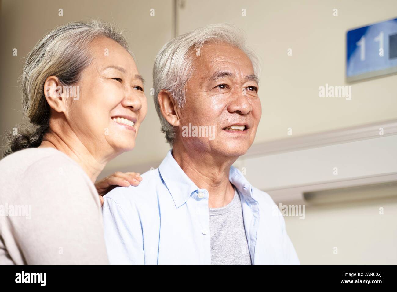 portrait of asian old couple sitting in on bed in hospital ward Stock Photo