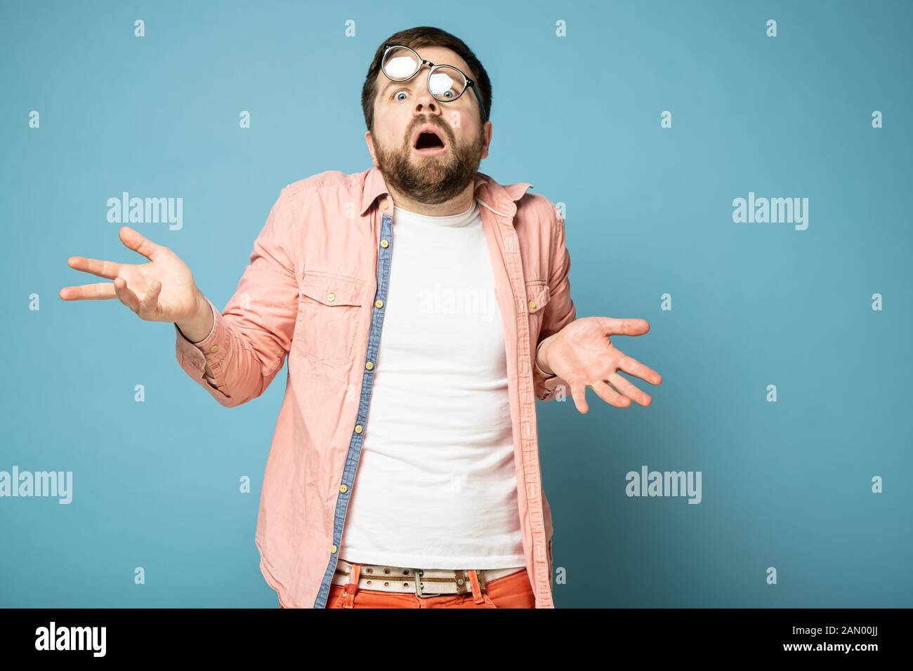 Stunned, caught unawares man with distorted glasses on face, throws up