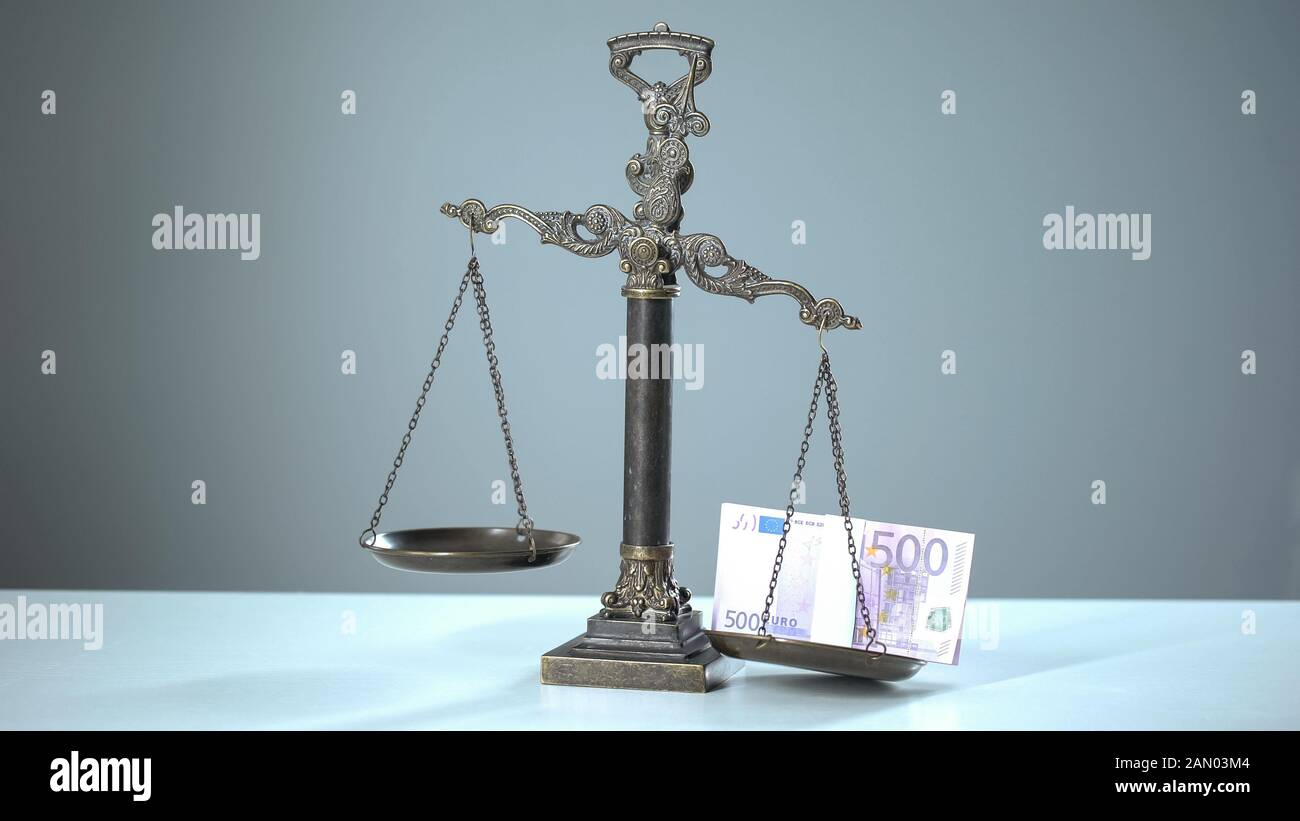 Euro banknotes dominates on scales, social inequality concept wealth and poverty Stock Photo
